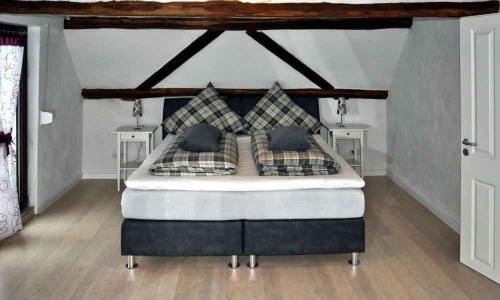a bedroom with a large bed with two night stands at Ferienhaus Gründaublick in Gründau