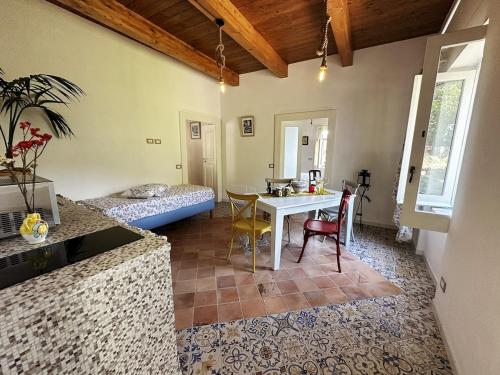 a kitchen and living room with a table and a bed at Casa Sangineto - Minori - Costa Amalfitana- A Paradise in the countryside in Minori