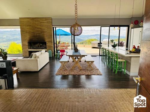 a living room with a table and a kitchen at TopSpot with Super View in the Guasca Mountains in Cundinamarca