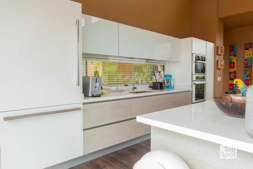 a white kitchen with white cabinets and a window at TopSpot with Super View in the Guasca Mountains in Cundinamarca