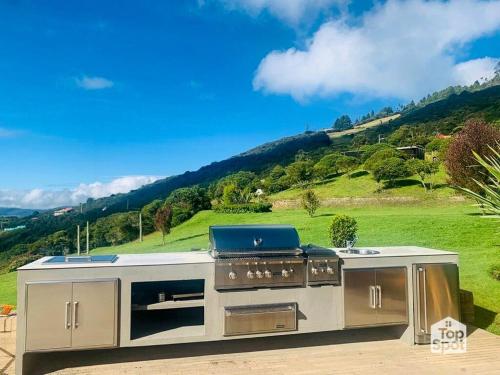 a kitchen with a stove with a hill in the background at TopSpot with Super View in the Guasca Mountains in Cundinamarca