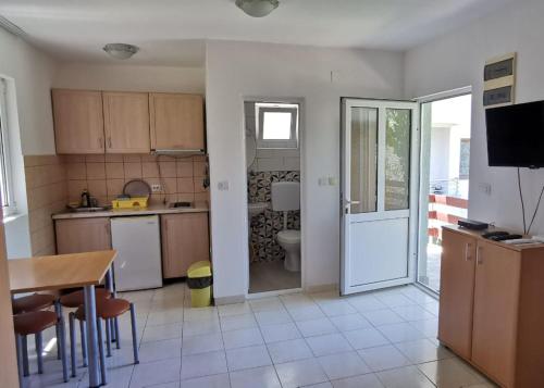 a kitchen with a door open to a bathroom at Apartments Val Maslina in Utjeha