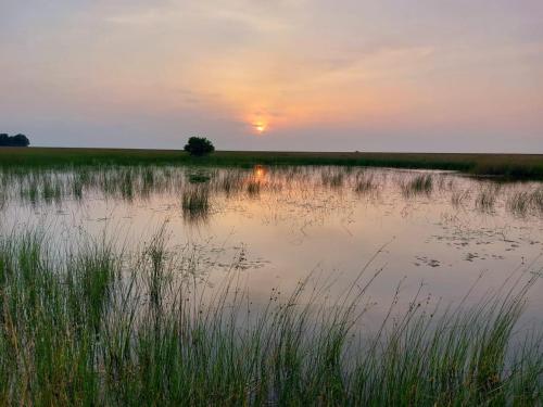 a body of water with the sunset in the background at La Maringa El Magnifico in Libreville