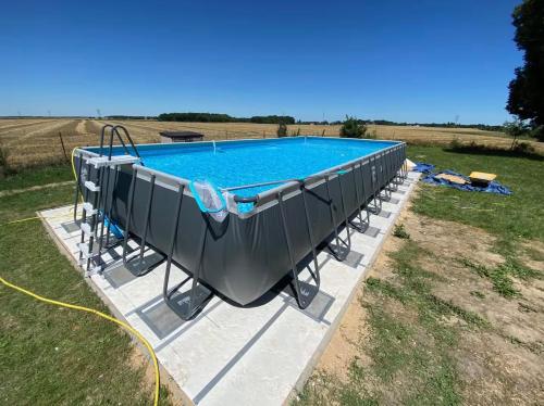 - une vue sur la piscine dans un champ dans l'établissement Maison de charme à 1h30 de Paris, à Nargis