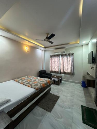 a bedroom with a bed and a couch in a room at Hotel The Heaven in Muzaffarpur