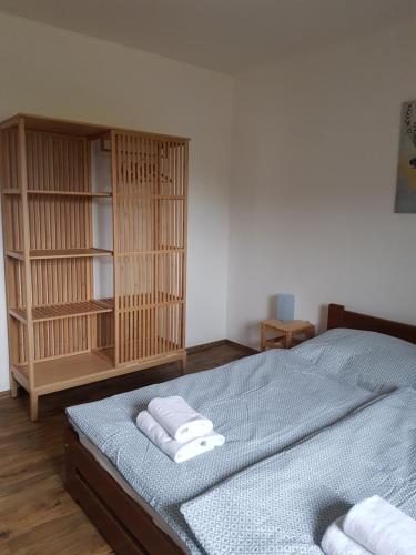 a bedroom with a bed with towels on it at Chata Kvilda in Kvilda