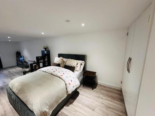 a bedroom with a bed and a wooden floor at Ash Residence City Centre in Aberdeen