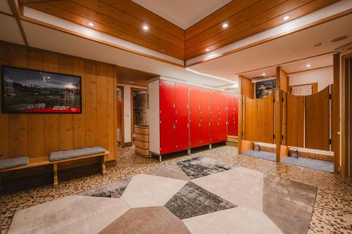 a room with wooden walls and a red wall at Sertorelli Sporthotel in Breuil-Cervinia