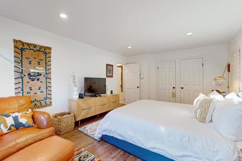 a bedroom with a large bed and a couch at Heron Escape in Bodega Bay