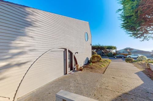 a white building with an archway on the side of it at Heron Escape in Bodega Bay