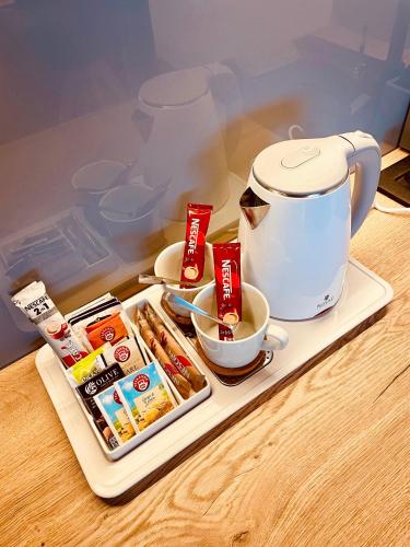 a tray with food and a cup of coffee on a table at Tee House - Forest Apartment Čeladná in Čeladná