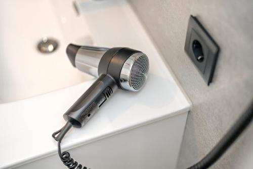 a hairdryer is attached to a wall at Fuchsmichelhof 3 in Seebach