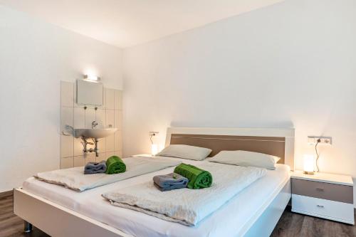 a bedroom with a large bed with two green bags on it at Fuchsmichelhof 3 in Seebach