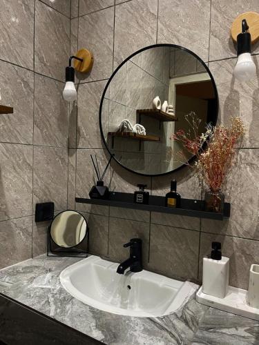 a bathroom with a sink and a mirror at Les apparts d Agathe in Brazzaville
