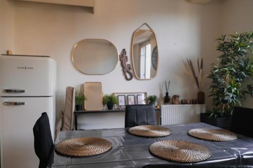 a dining room table with chairs and a refrigerator at Grande Terrasse Hyper-Centre Quiet & Cozy for 2 in Foix