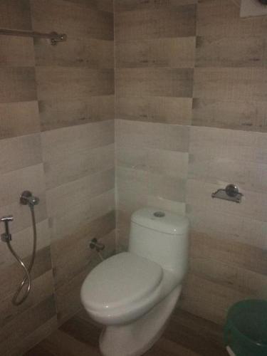 a bathroom with a toilet and a shower at Adam's Heaven in Alleppey