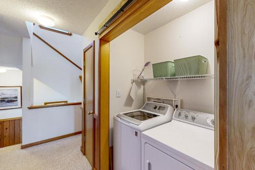 a laundry room with a washer and dryer at Rogue Wave 146 in Avon