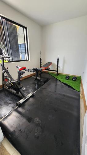 a room with a gym with two bikes and a simulator at La terraza departamentos 402 in Cuenca