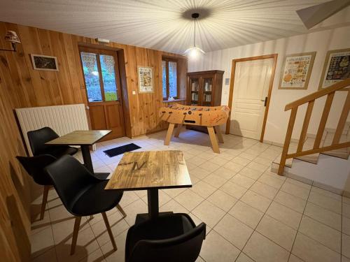 a room with two tables and a ping pong table at Auberge du Ruxelier J&D in Cheniménil