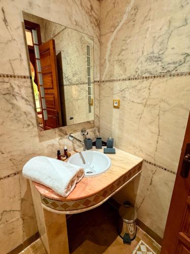 a bathroom with a sink and a mirror at VILLA 34 - 4 Masters, Moroccan Charm & Modern Comfort with Private Pool in Marrakesh