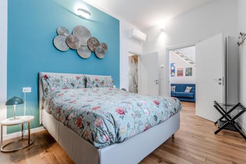 a bedroom with a bed and a blue wall at Casa Fossato in Bologna