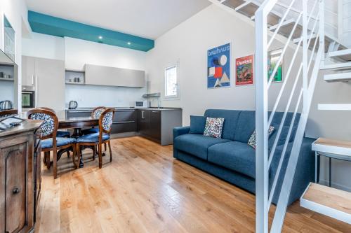 a living room with a blue couch and a table at Casa Fossato in Bologna