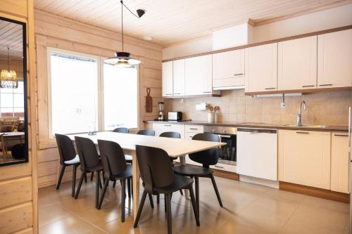 a kitchen with a table and chairs in it at Villa Pyry in Vuokatti