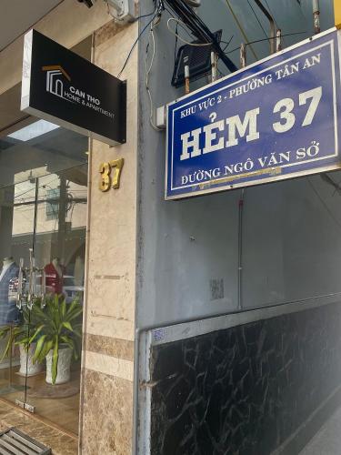 a sign on the side of a building with a him sign at Can Tho Home & Apartment 1 in Can Tho