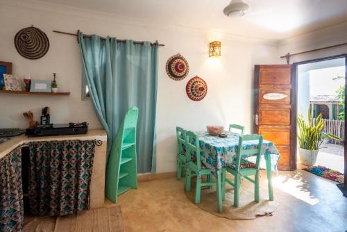 a kitchen with a table and chairs in a room at FURAHA VILLA 3 in Chanjani