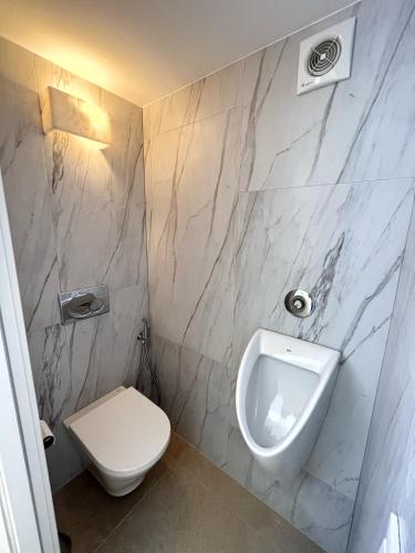 a bathroom with a white toilet and a urinal at Casa pi in Bunyola