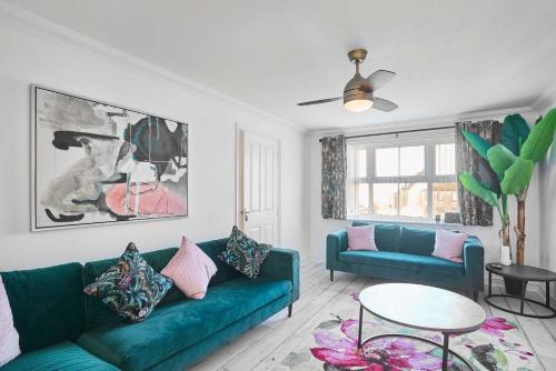 a living room with a green couch and a table at Host & Stay - Cherry Blossom House in Launceston