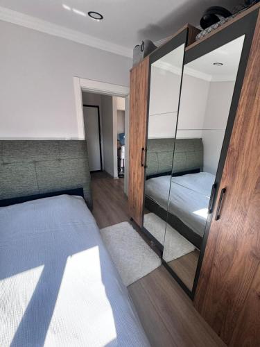 a bedroom with two beds and a mirror at ByLotos in Side