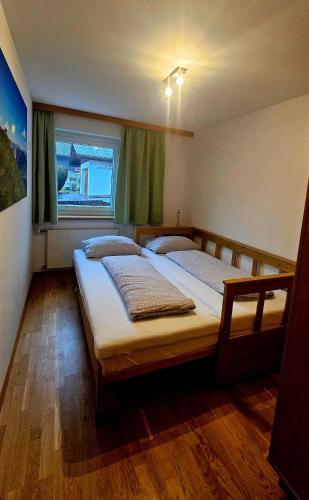 two beds in a bedroom with a window at Haus Mangeng in Vandans