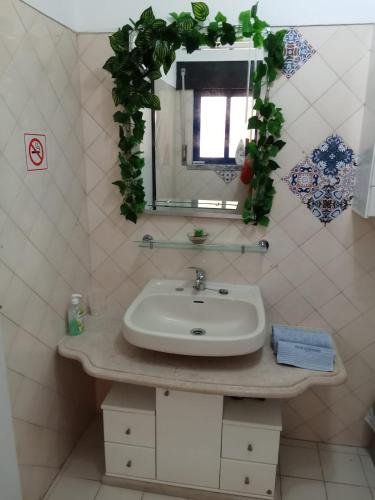 a bathroom with a sink and a mirror at Casa Susana in Atouguia da Baleia
