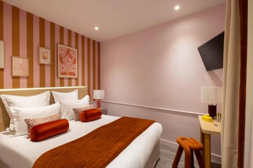 a hotel room with a bed and a desk at Hotel La Folie des Pres - Saint-Germain-des-Pres in Paris