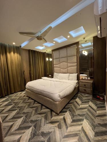 a bedroom with a large bed in a room at Courteous Hotel in Islamabad