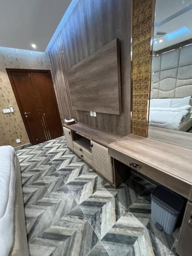 a hotel room with a large mirror and a bed at Courteous Hotel in Islamabad