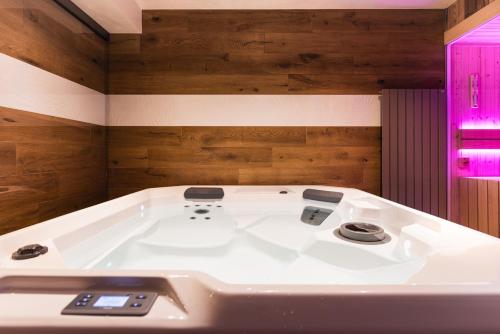 a white bath tub in a room with wooden walls at Sertorelli Sporthotel in Breuil-Cervinia