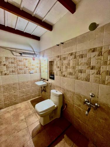 a bathroom with a toilet and a sink at Sabera Heritage Homestay in Sakleshpur