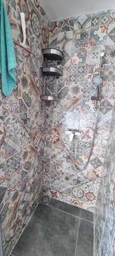 a bathroom with a shower with a tile wall at Southern Sun in Tilburg