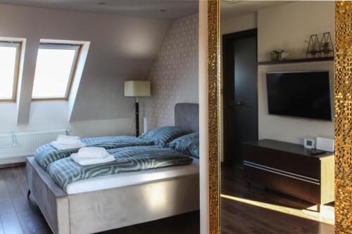 a hotel room with a bed and a mirror at AB Stúdió in Szombathely
