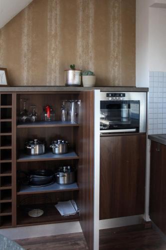 a kitchen with a stove and some pots and pans at AB Stúdió in Szombathely