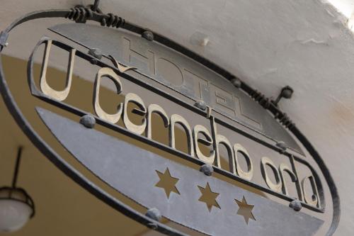 a sign for a restaurant with stars on it at Hotel U Černého orla in Telč