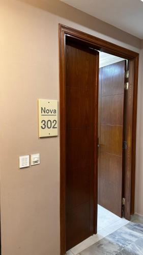 a sign that reads is on a door at Nova Plex Apartments in Jhelum