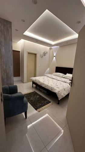 a bedroom with a bed and a couch and a chair at Nova Plex Apartments in Jhelum