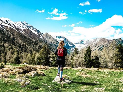 a woman standing on a rock on a mountain at Apartments Schrim in Fiegler