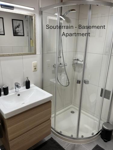a bathroom with a shower and a white sink at Haus Carinthia in Pettneu am Arlberg
