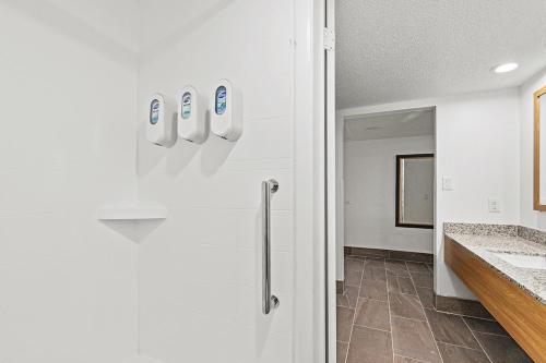 a white bathroom with a sink and a counter at The Reef At Seahaven Beach Resorts in Panama City Beach