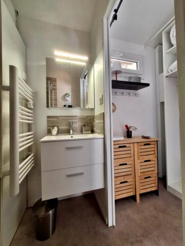 une petite salle de bain avec un lavabo et un miroir dans l'établissement De l'eau et des oiseaux !, à Saintes-Maries-de-la-Mer