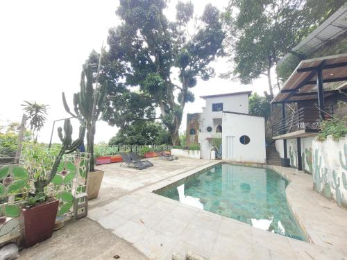 a swimming pool in a yard with a house at soulrebel rio - Vegan Retreat & SPA in Rio de Janeiro